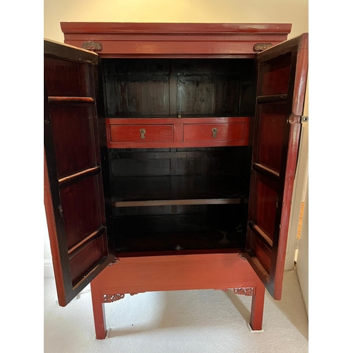 25 - A Chinese red lacquer wedding cabinet (H172cm W102cm D65cm)