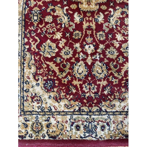 270 - A red ground rug (110cm x 60cm)