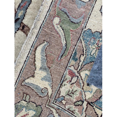 271 - A beige ground rug with floral pattern and geometric boarder *97cm x 152cm)