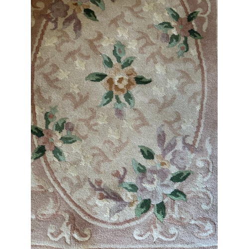 272 - A brown rug with a floral motif (62cm x 104cm)