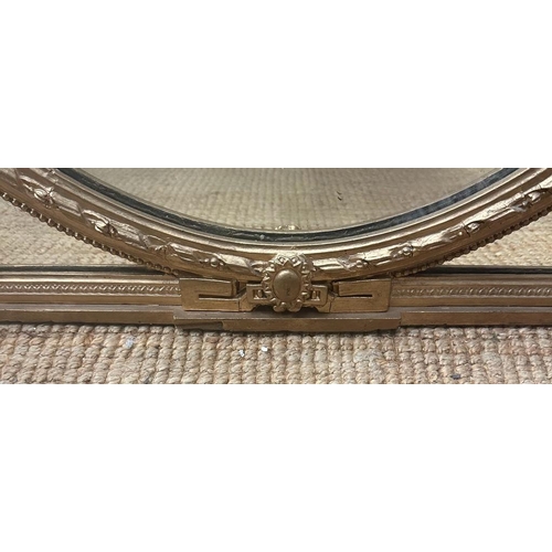 279 - A large gilt framed oval over mantel mirror in Coco style AF (H117cm W121cm)