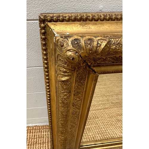 283 - A gilt framed wall hanging over mantel mirror (63cm x 110cm)