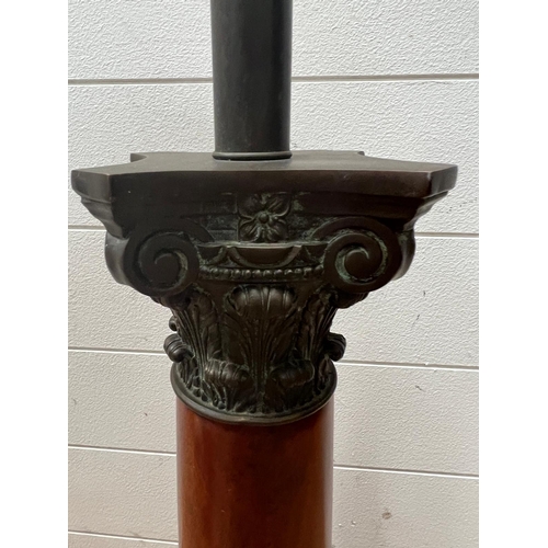 322 - A single column wooden lamp base, with bronze top Height 68cm