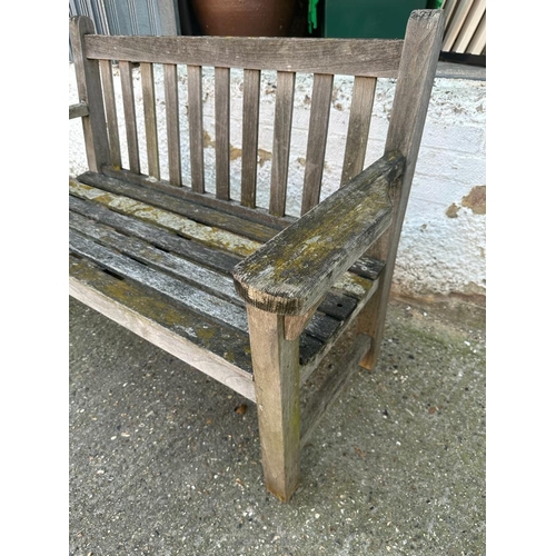 329 - A wooden two seater garden bench (H90cm W133cm D62cm)