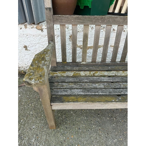 329 - A wooden two seater garden bench (H90cm W133cm D62cm)