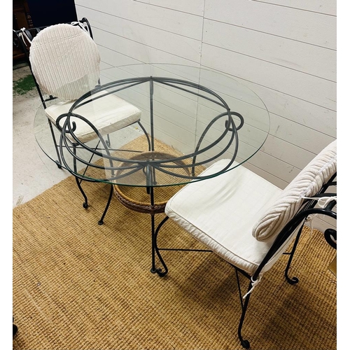 332 - A wrought iron glass top garden table with two wrought iron chair with cream cushions (H75cm Dia99cm... 