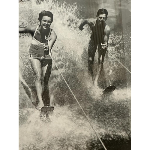 422 - A framed black and white photograph of a 1950's water skiing party 69x49