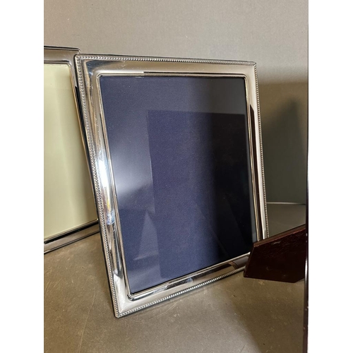 430 - A selection of three silver picture frames, largest is 32 cm x 27.5 cm