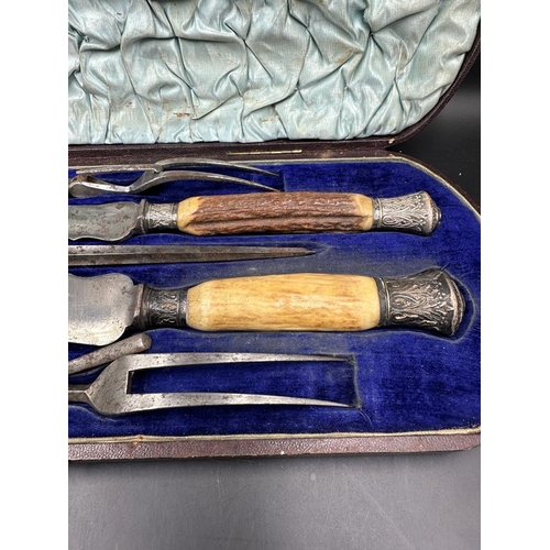 457 - A cased carving set with silver mounts and horn handles