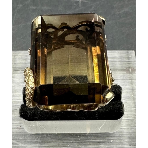 461 - A 9ct gold smokey quartz ring in an ornate setting.