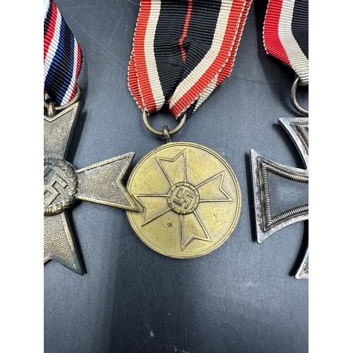 496 - Three German WWII medals to include A Merit Medal, War Merit Cross and an Iron Cross