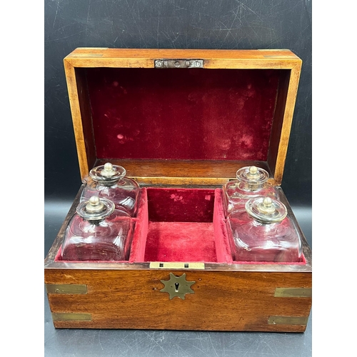 530 - A campaign style brass banded decanter box with four glass and silver topped decanters. Dated 1832 t... 