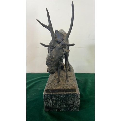 534 - A bronze sculpture of a panther seizing a stag on a marble based, signed (H32cm W30cm)