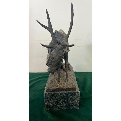 534 - A bronze sculpture of a panther seizing a stag on a marble based, signed (H32cm W30cm)