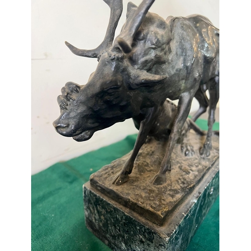 534 - A bronze sculpture of a panther seizing a stag on a marble based, signed (H32cm W30cm)