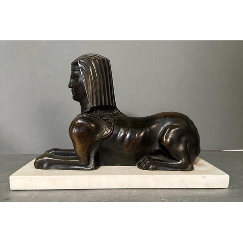 539 - A Bronze cast of a Sphynx with typical head-dress on a marble base (29cm x 12cm base)