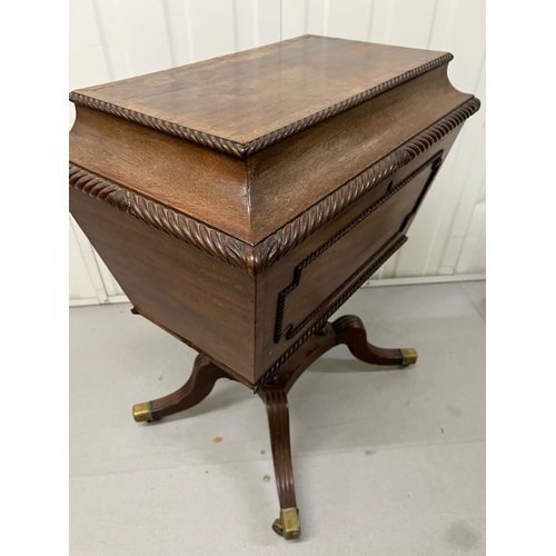 55 - A Regency style Cellarette. The Mahogany caddy opening to compartments and panelled front. Terminati... 