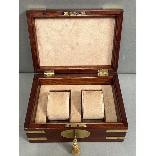 553 - A brass banded watch box with key, two watches.