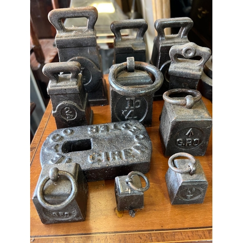 554 - A sizeable collection of cast iron scale weights, various makers and weights.