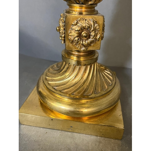 555 - A brass candlestick on square base and twisted form (37cm H )