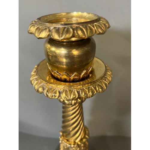 555 - A brass candlestick on square base and twisted form (37cm H )