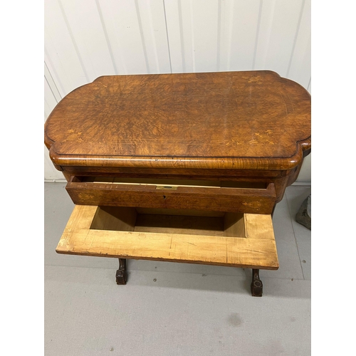 56 - A Victorian Burr Walnut Games Table. The table top opens to reveal Chess, back gammon and cribbage b... 