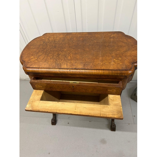 56 - A Victorian Burr Walnut Games Table. The table top opens to reveal Chess, back gammon and cribbage b... 