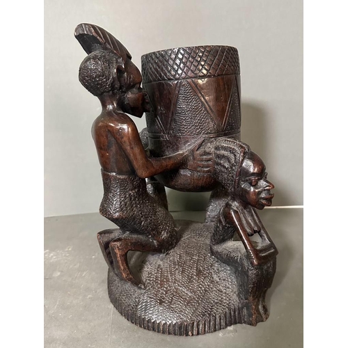 563 - A Heavy East African carved pot on stand. 32cm H