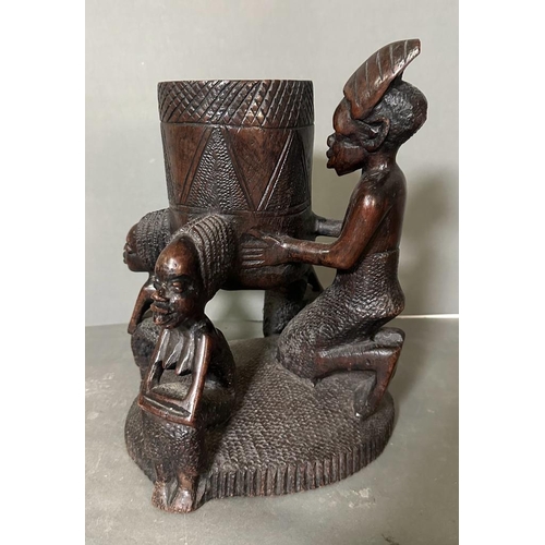 563 - A Heavy East African carved pot on stand. 32cm H