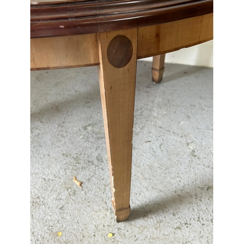 61 - An oval side table with inlaid top on tapering legs by Brights of Nettle bed