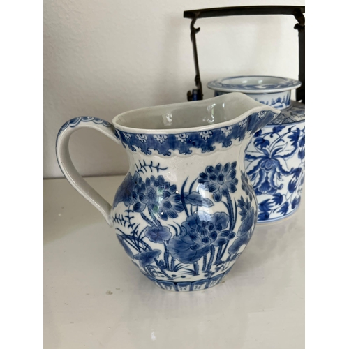 611 - Oriental blue and white china, one jug and a metal handled teapot.