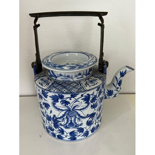 611 - Oriental blue and white china, one jug and a metal handled teapot.