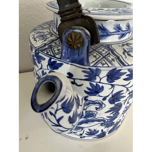 611 - Oriental blue and white china, one jug and a metal handled teapot.