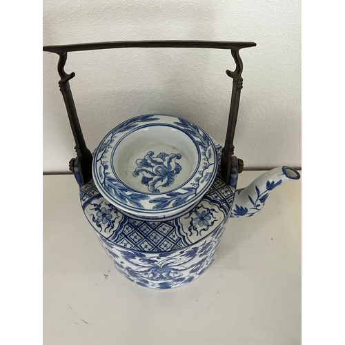 611 - Oriental blue and white china, one jug and a metal handled teapot.