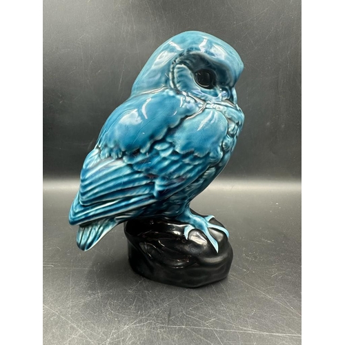 618 - Two Poole pottery blue dolphin glaze animals. An owl on a black plinth and an otter