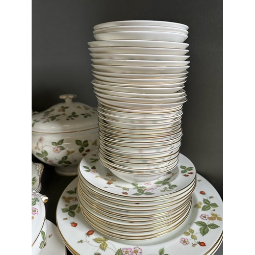 630 - A substantial dinner and tea service by Wedgewood in the wild strawberry pattern