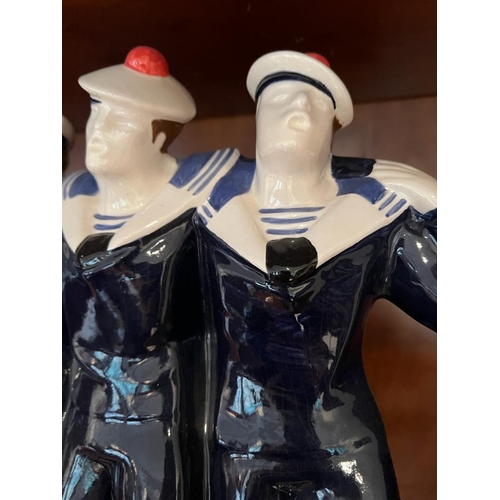 635 - A china figure of a sailor by Fab Quimper ware (H31cm W35cm)