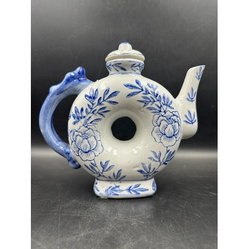 639 - A selection of four Chinese blue and white tea pots to include a doughnut shaped and a miniature ele... 