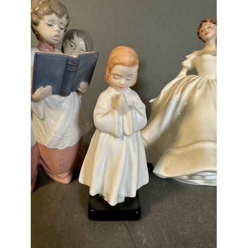 643 - A Lladro figurine of Choristers and two Royal Doulton Nancy and Bedtime