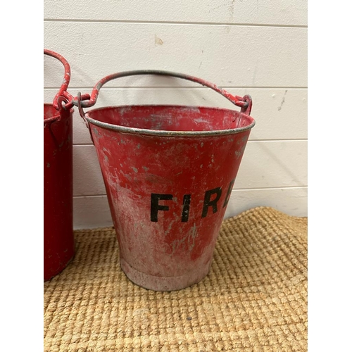 673 - Two vintage red fire buckets