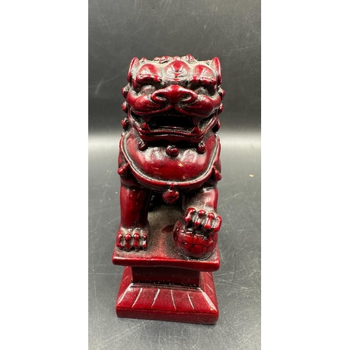 695 - A pair of red resin Chinese foo dogs