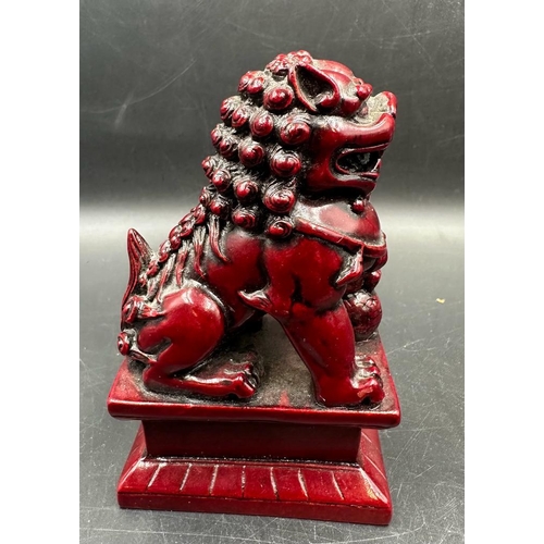 695 - A pair of red resin Chinese foo dogs