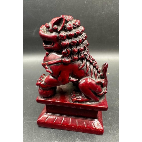 695 - A pair of red resin Chinese foo dogs