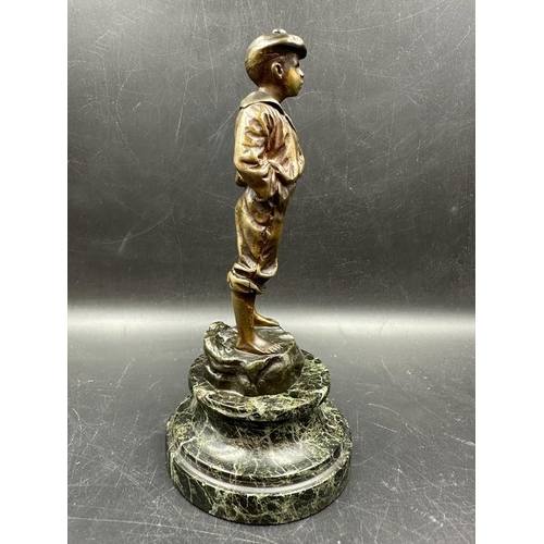 696 - A bronze sculpture of a boy whistling 