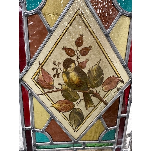 699 - A selection of three leaded stained glass panels, one featuring the number 16. 103x30