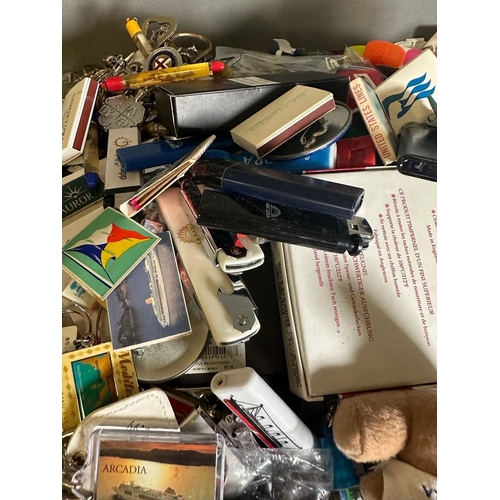 703 - A large quantity of cruise liner collectables and ephemera to include key chains, bottle openers and... 