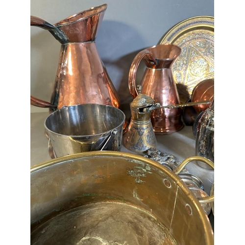 706 - A selection of copper, brass and white metal items to include jugs, trays and a coal scuttle