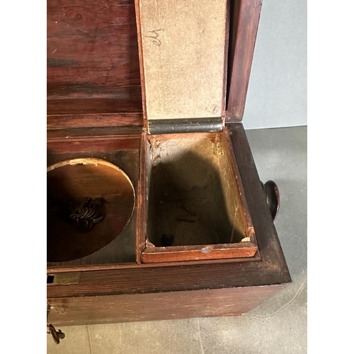 708 - A mahogany tea caddy with mother of pearl inlay and turned handles