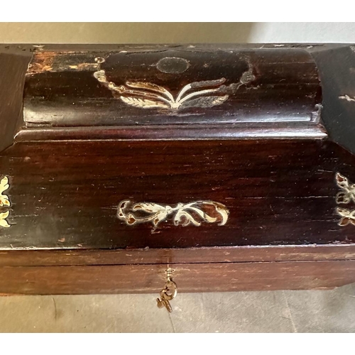 708 - A mahogany tea caddy with mother of pearl inlay and turned handles