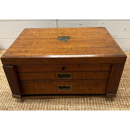 727 - An oak cutlery traveling canteen with hinged lid and two drawers to base.